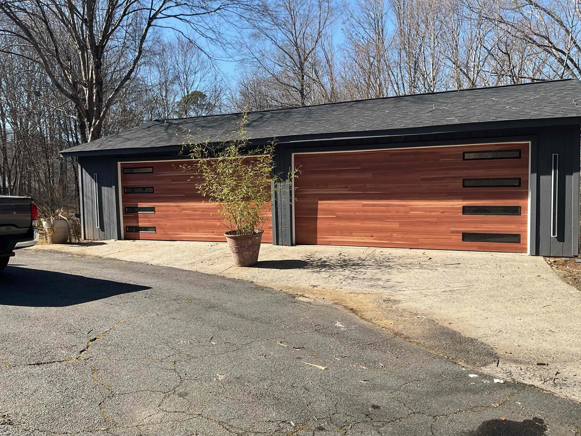 Modern cedar garage doors installed on a detached garage