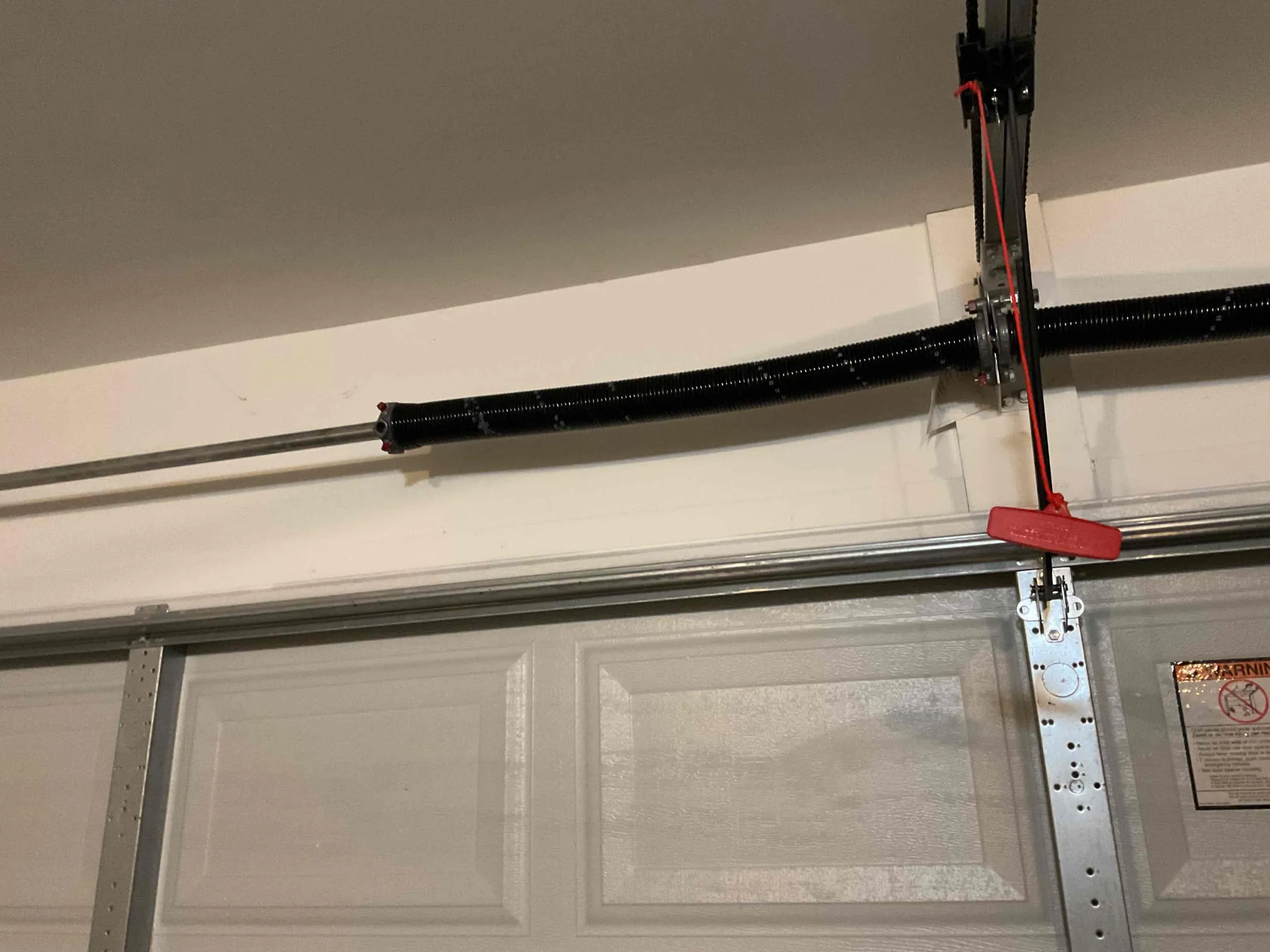 Completed torsion spring system above a residential garage door