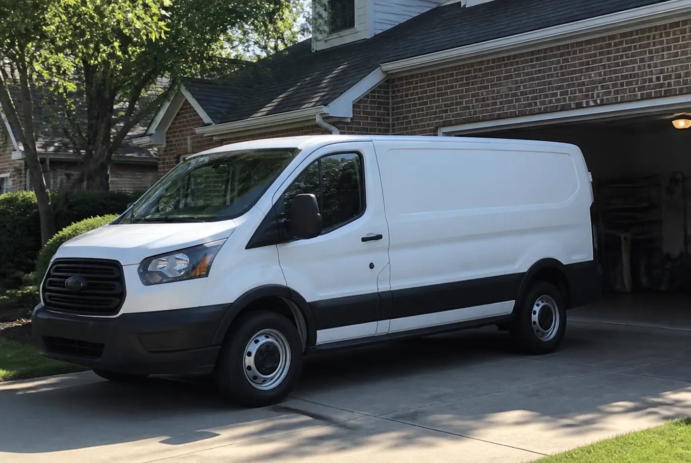 Service van parked in a North Atlanta driveway beside an open garage